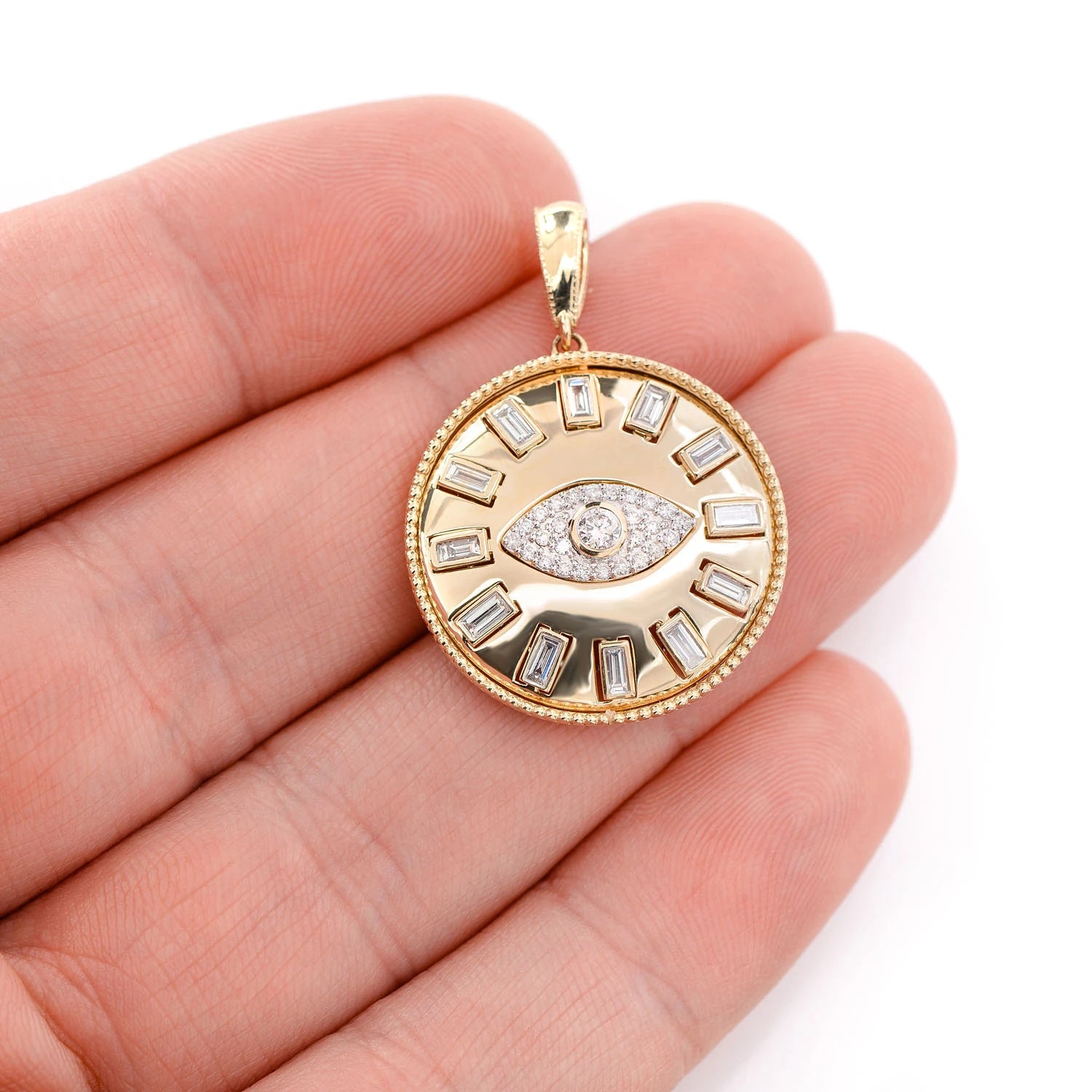 Evil Eye Baguette Diamond Medallion Pendant in 14K yellow gold, angled view