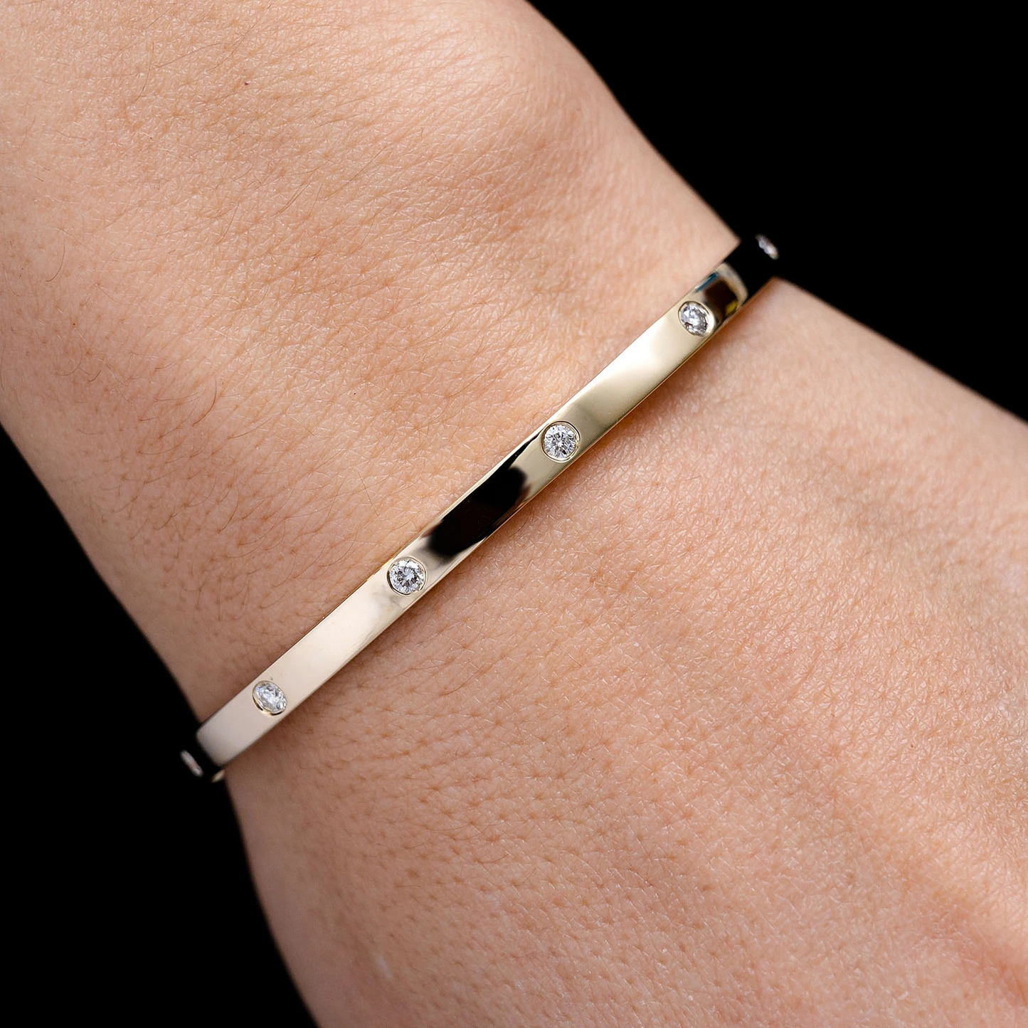Thin Flush Set Diamond Bangle Bracelet in 14K yellow gold, angled view